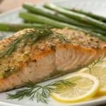 Perfectly baked lemon herb salmon with fresh dill and lemon slices.