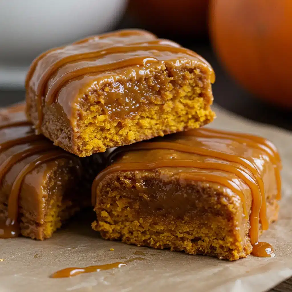 Stack of pumpkin caramel blondies topped with gooey caramel sauce, showing moist texture and rich filling.