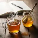 glass mug of warm honey and cinnamon for memory recipe on a wooden table