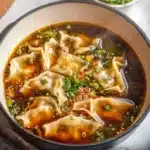 A delicious bowl of homemade Potsticker Soup with dumplings and veggies