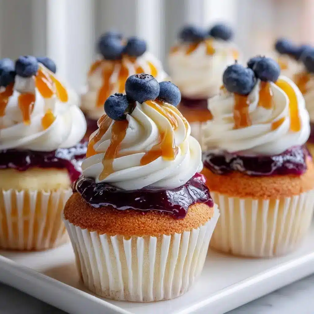 Blueberry pancake cupcakes topped with fresh blueberries and syrup
