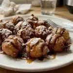 Crispy air fryer funnel cake bites sprinkled with powdered sugar