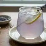 Coconut Lavender Lemonade mocktail served in a glass with fresh lavender sprigs.