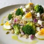 Quinoa salad with egg and broccoli in a colorful bowl